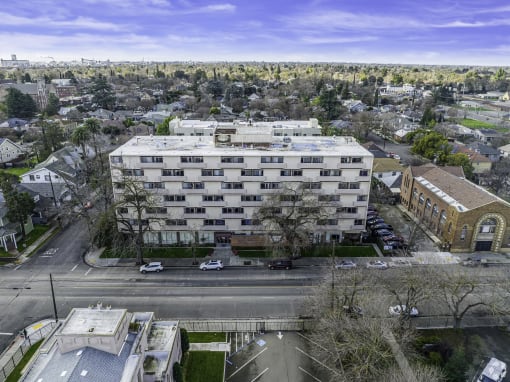 an aerial view of a large white building in a city