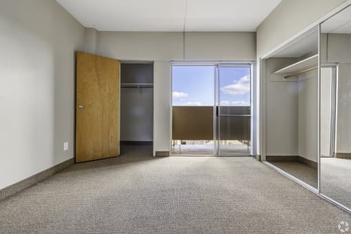 a empty room with a door to a balcony