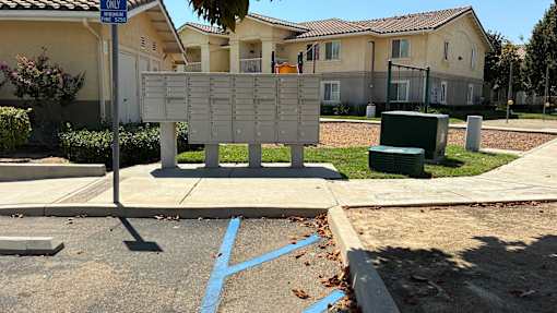 A sign with a list of names is in front of a building.