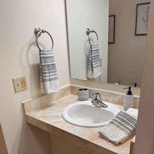A bathroom with a sink and a mirror.