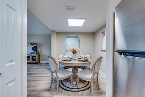 A dining room with a table set for two.