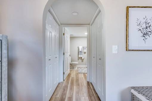 A hallway with a framed picture on the wall.