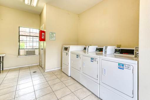 A laundry room with washers and dryers.