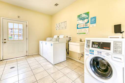 A laundry room with a washer and dryer, a washing machine, and a washing machine.