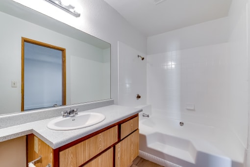 a bathroom with a sink and a bathtub at Pacific Harbors Sunrise Apartments, Las Vegas, NV