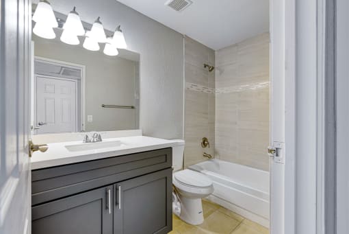 a bathroom with a sink toilet and a tub
