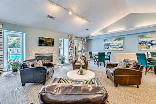 A living room with a fireplace and a painting on the wall.