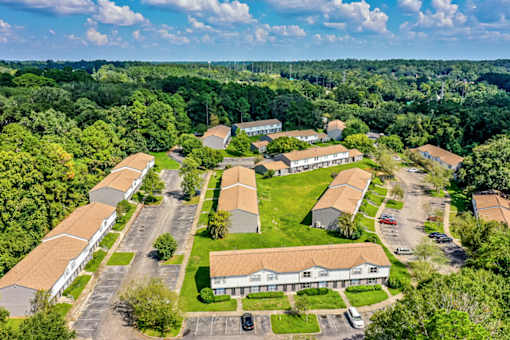A bird's eye view of a residential area with houses and cars.