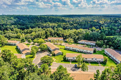 A bird's eye view of a residential area with houses and trees.