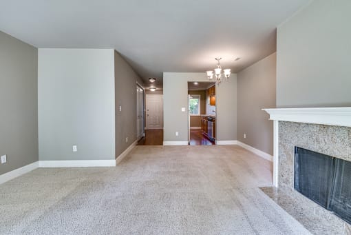 Living Room with fireplace and kitchen at Village at The Pointe Apartments, Tacoma