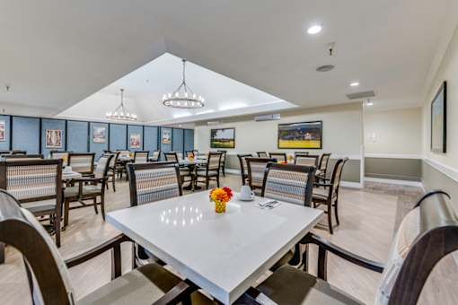 A dining room with a table set for two.