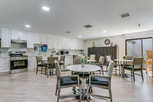 A modern kitchen with a dining table and chairs.