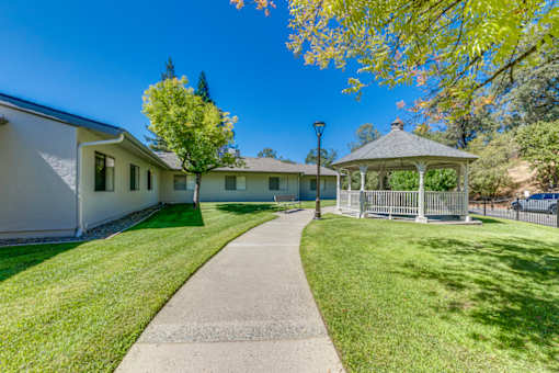 A white building with a gazebo in front of it.