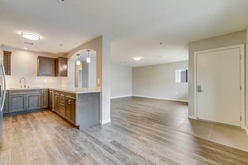 A spacious kitchen with wooden floors and a large island.