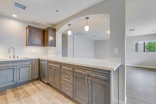 A kitchen with wooden cabinets and a white countertop.