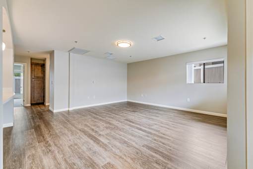 A room with wooden flooring and white walls.