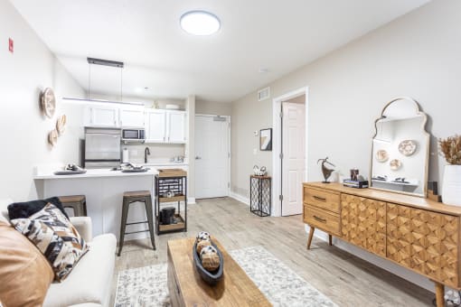 a living room and kitchen with a couch and a table