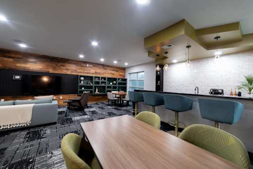 a living room and dining room with a table and chairs
