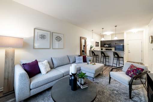 a living room with a couch and a table and a kitchen