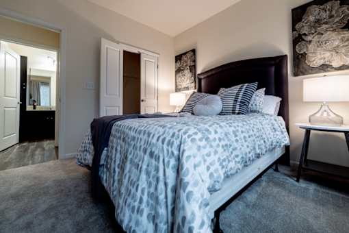 a bedroom with a large bed and a bathroom