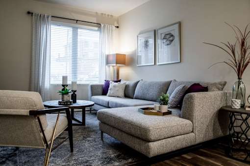 a living room with couches and chairs and a table