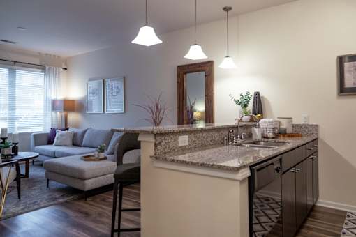 an open kitchen and living room with a counter top