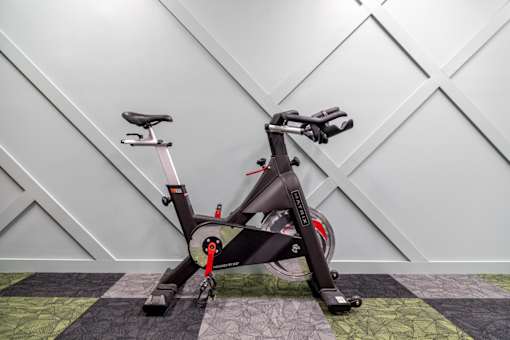 an exercise bike parked in a home gym