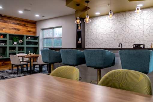 a dining room with a wooden table and chairs