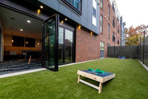 a yard with a table and a brick building
