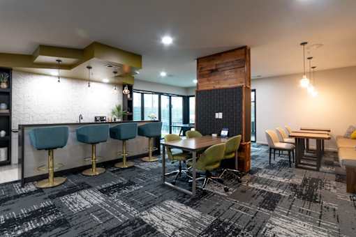 a dining room with a table and chairs and a bar