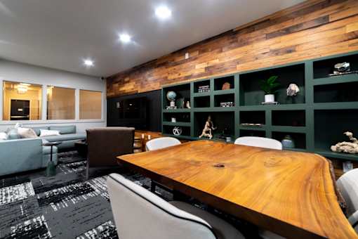 a conference room with a wooden table and green walls
