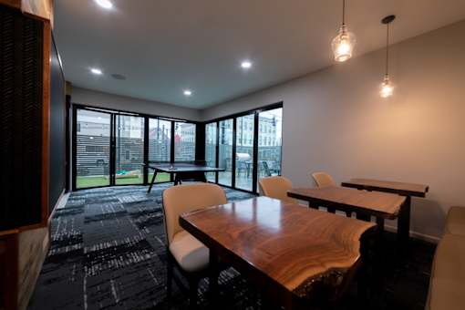 a conference room with a wooden table and chairs and large windows