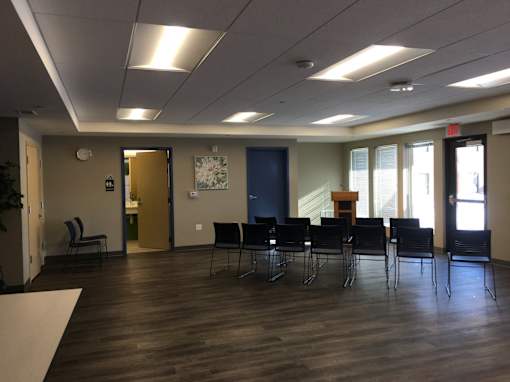 A room with a long table and chairs.