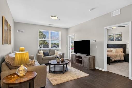 A living room with a couch, chair, and coffee table.