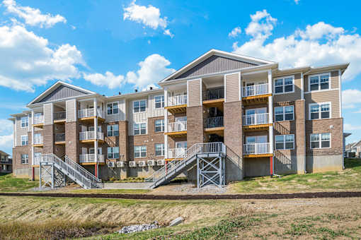 an exterior view of an apartment building with stairs