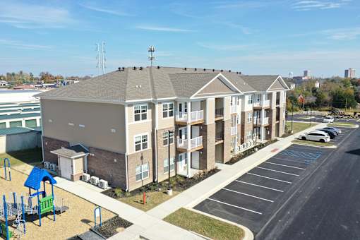 an aerial view of an apartment building with a parking lot