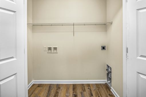 an empty room with white walls and a wood floor