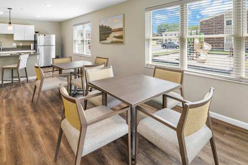 A dining room with a table and chairs.