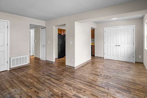 A room with wooden floors and white walls.