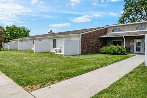 A building with a brick wall and a white garage door.
