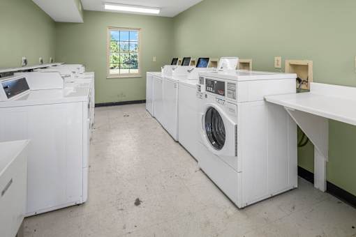 A laundry room with washers and dryers.