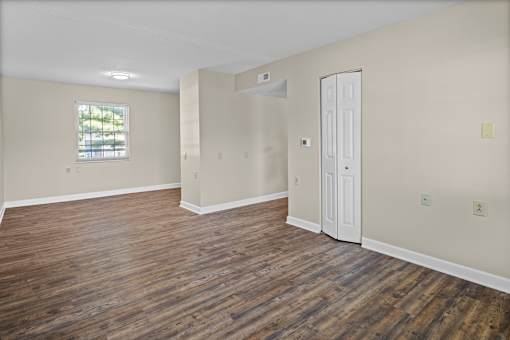 A room with wooden floors and a window.