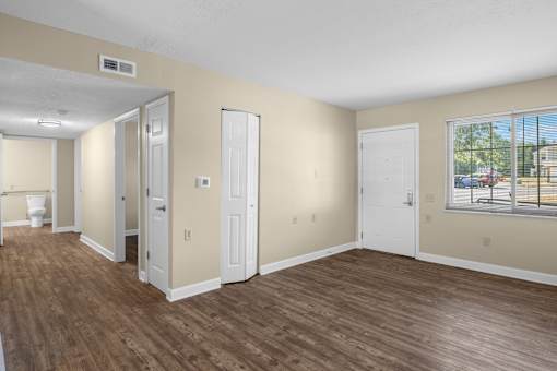 A room with wooden floors and white doors.