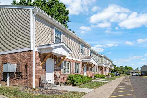 A row of houses with a clear blue sky above them.