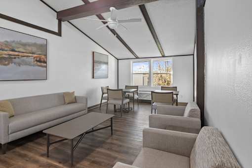 A living room with a couch, chairs, and a coffee table.