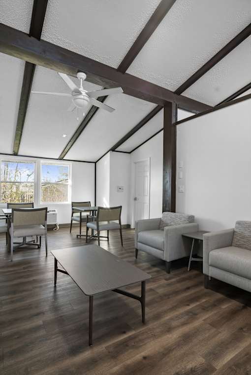 A living room with a table and chairs.
