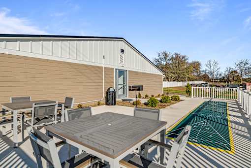 A patio area with a table and chairs outside a building.