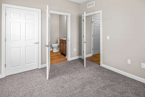 A white door is open to a bathroom.