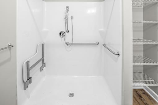 A white bathroom with a walk in shower.