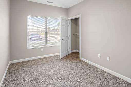 A room with a car parked outside the window.